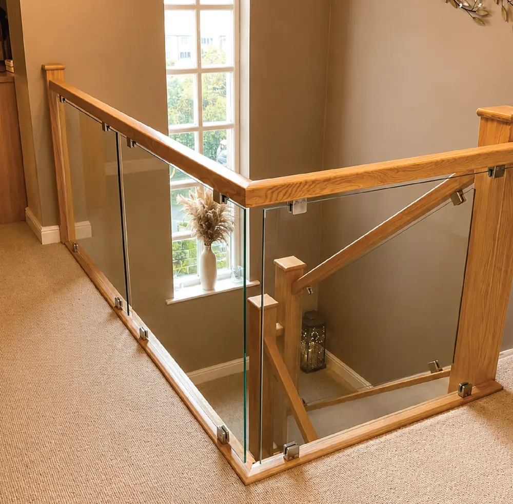 Oak and glass balustrade to a first-floor landing with a hardwood handrail