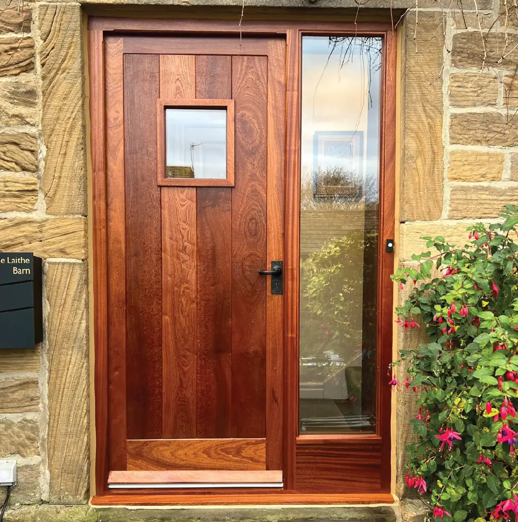 Hardwood front door with a glazed sidelight in a stone barn conversion