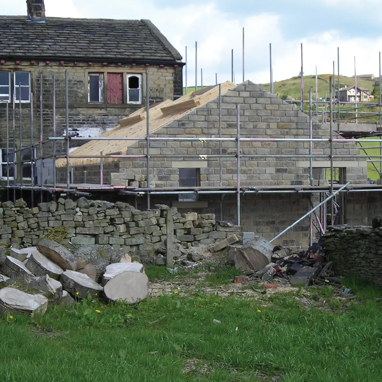 Barn conversion under scaffolding with new roof timbers in place