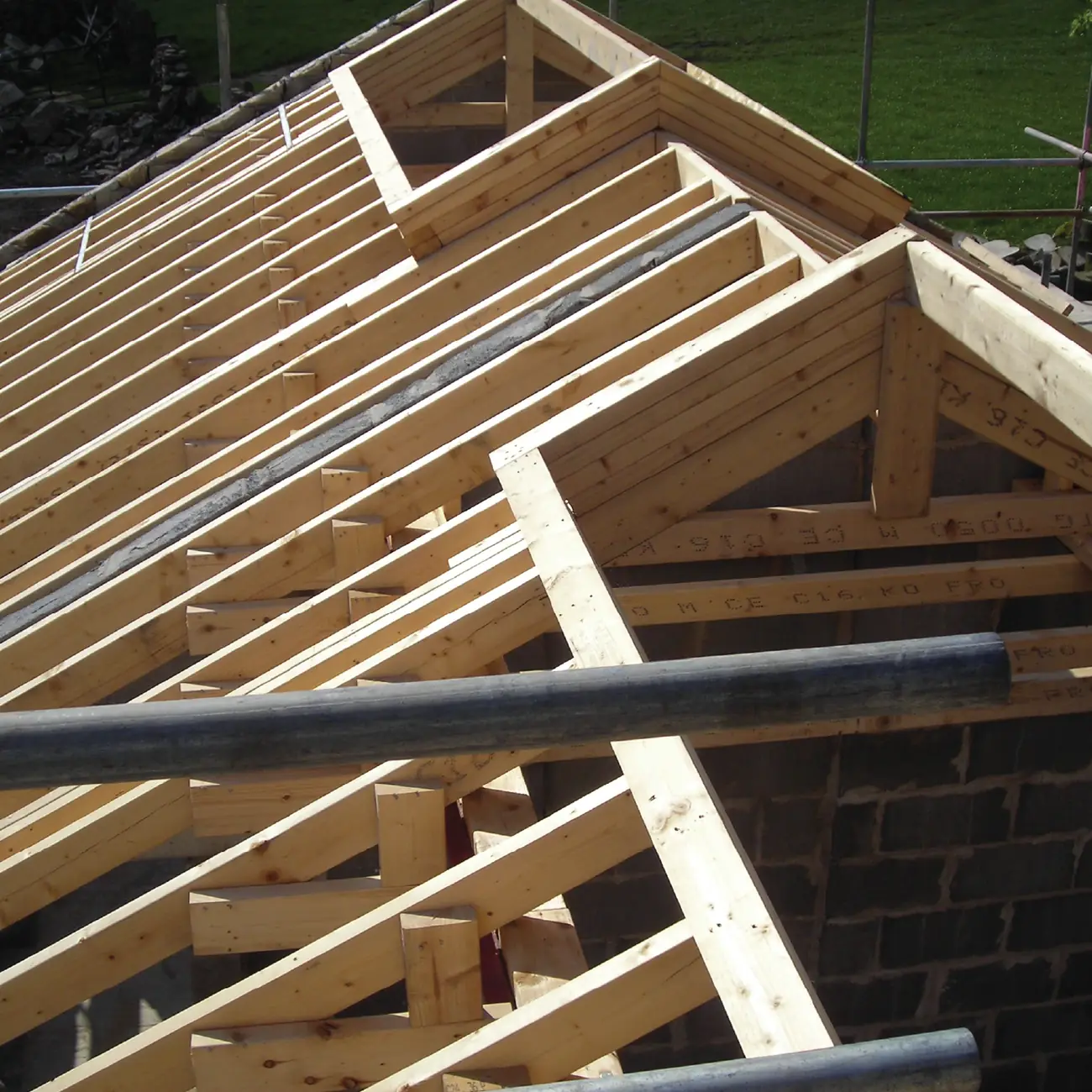 New roof trusses and purlins erected over the barn walls