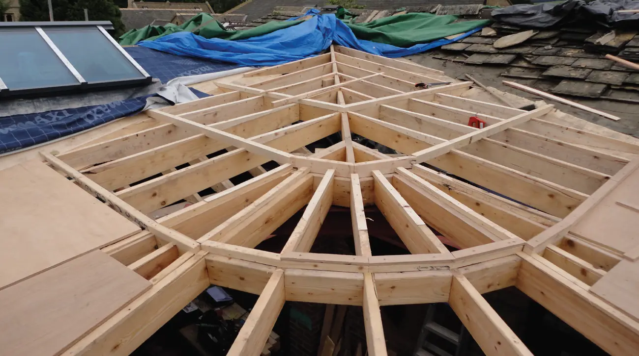 Radial timber roof structure set out on site during construction