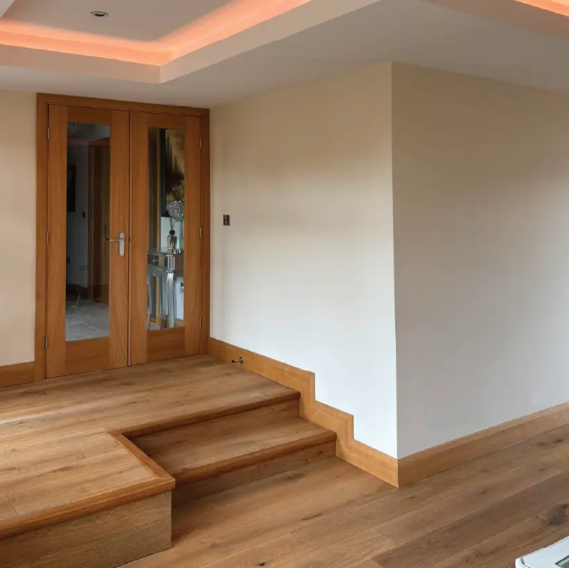 Oak glazed doors and a stepped threshold to the converted garage room