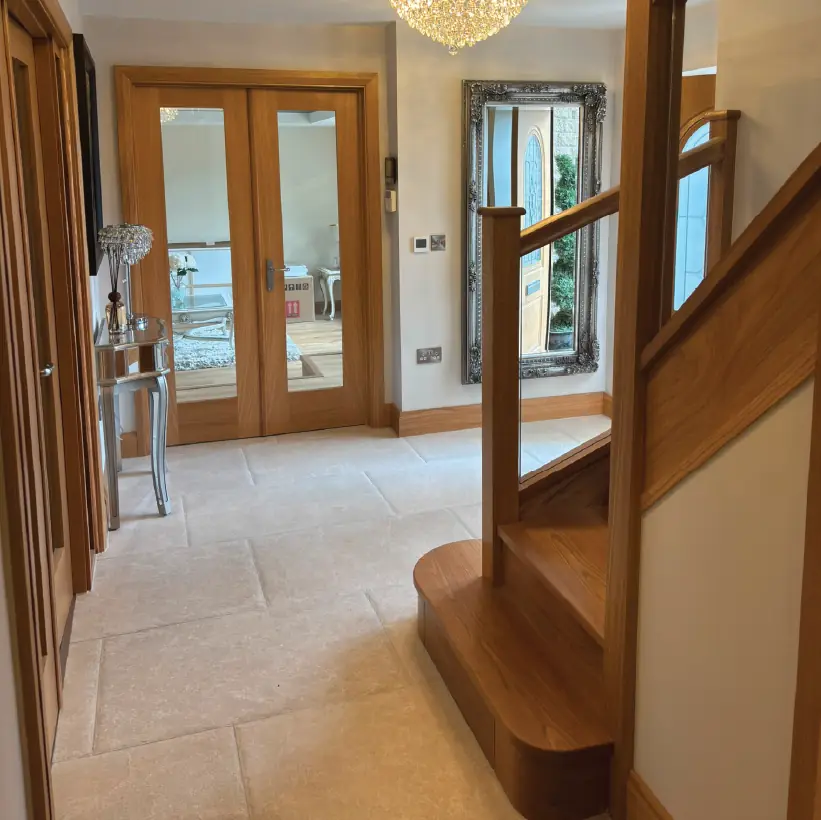 Hallway with oak glazed double doors and a curtail step to the staircase
