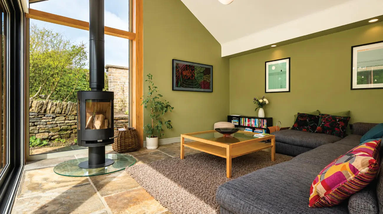 Open-plan living space with a freestanding wood burner and a vaulted ceiling