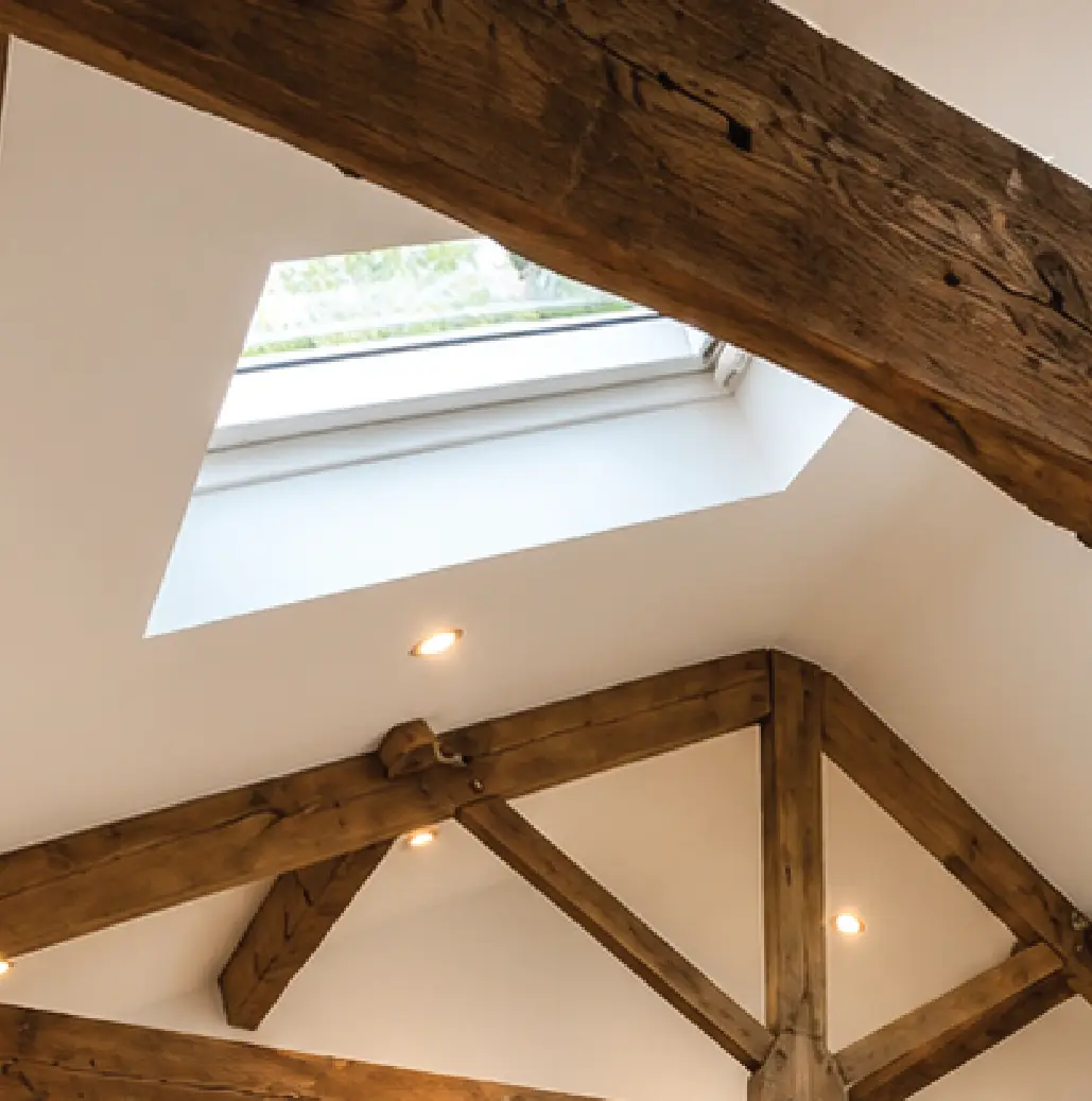Rooflight set between reclaimed oak trusses in a converted loft
